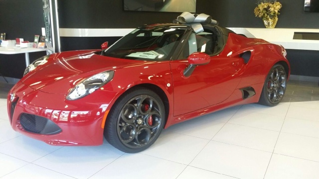 Red Alfa Romeo Spider in a showroom by CarData